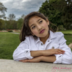 Thoughtful girl in white jacket outdoors