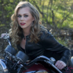 Woman in leather jacket on motorcycle