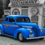 Bright blue 1930s coupe in retro gas station