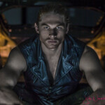 Muscular man in leather vest, intense gaze