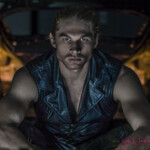 Muscular man in leather vest, intense gaze