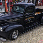 Black vintage pickup truck at retro gas station