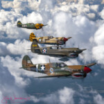 Four WWII P-40 fighters with shark mouths