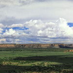 Panoramic valley with mesas under cloudy sky