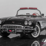 Black classic Chevrolet Corvette convertible with red interior