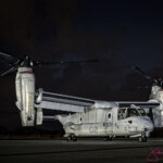 V-22 Osprey tiltrotor aircraft on runway at night