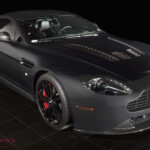 Matte black Aston Martin coupe with red calipers