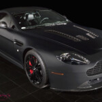 Matte black Aston Martin coupe with red calipers